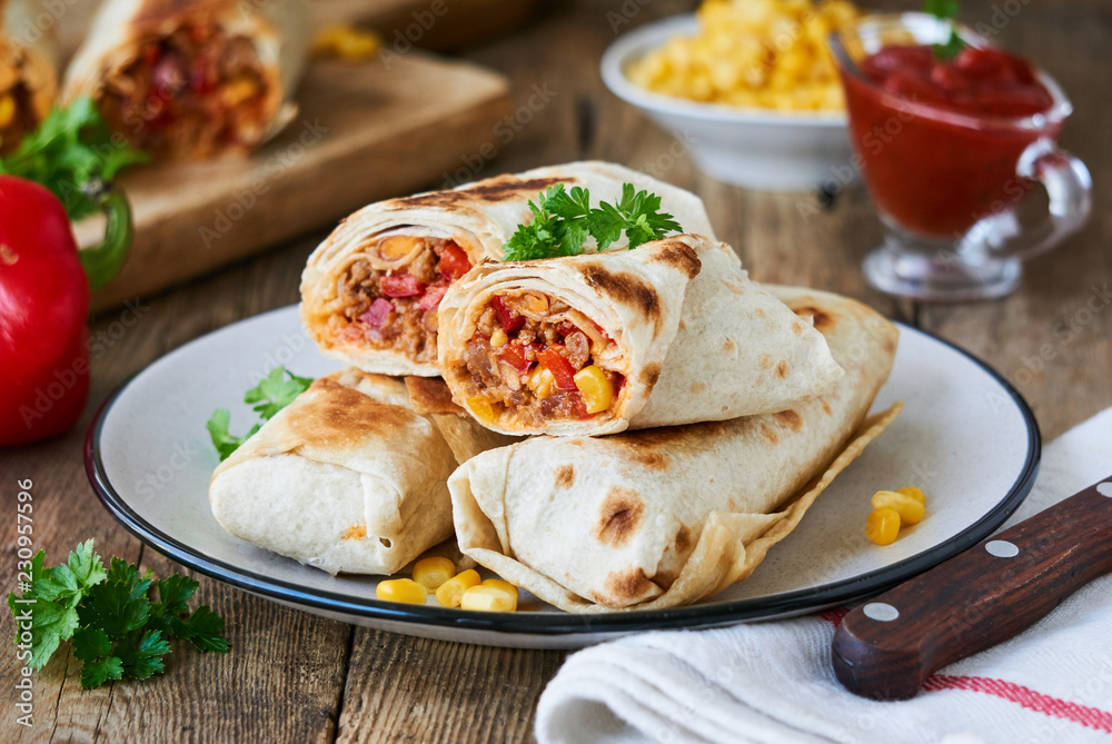 Burrito with ground beef and vegetables on a plate Burrito with ground beef and vegetables on a plate
