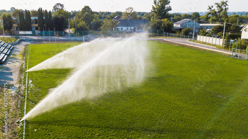 Aerial view of watering the lawn of a football field