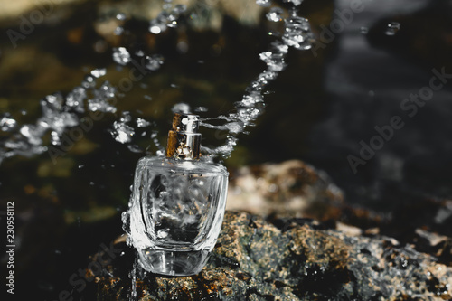 perfume with water drops at sea bacground