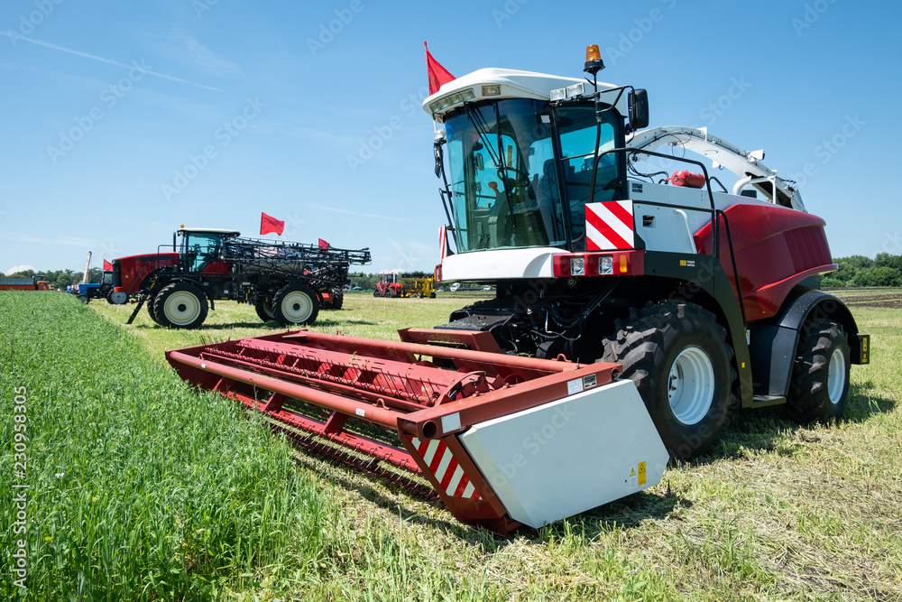 heavy powerful red harvester in the field during the demonstration heavy powerful red harvester in the field during the demonstration