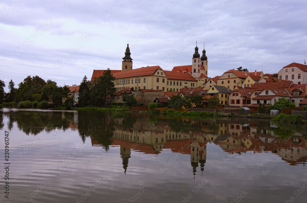 Scenic morning view of medieval Telc at sunrise. Buildings are reflected in the water. Famous touristic place and travel destination in Europe. A UNESCO World Heritage Site. Telc, Czech Republic