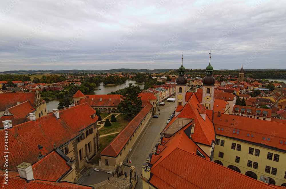 Red tile roofs in medieval city. Aerial view of Telc with main square and towers of the Church of the Holy Name of Jesus. A UNESCO World Heritage Site. Telc, Czech Republic