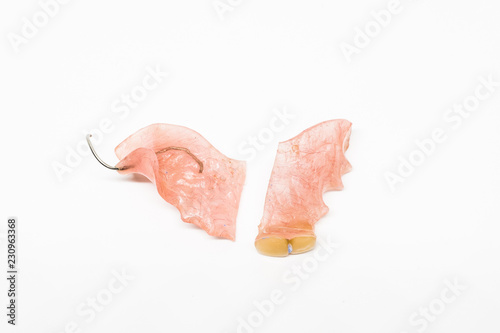 broken denture on white background