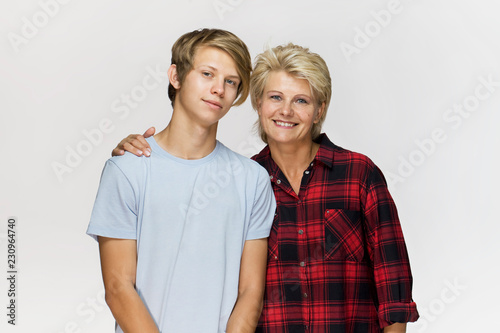 Happy and smiling mother and son. Loving family portrait against white background