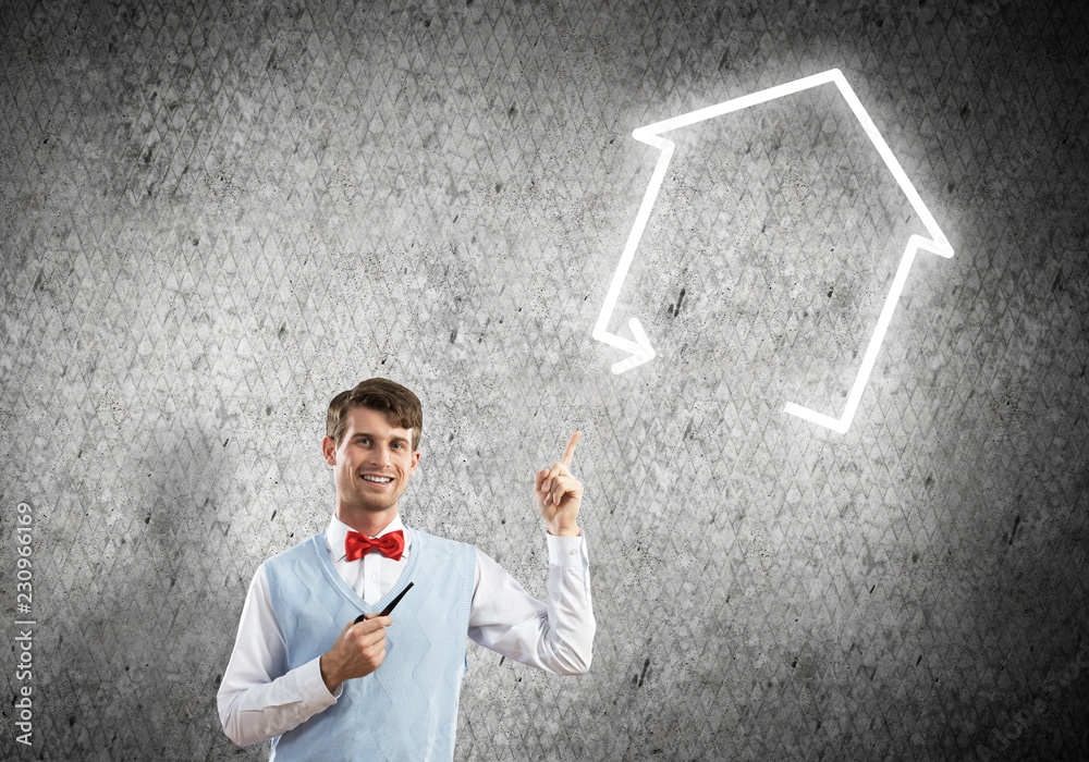 Elegant banker wearing red tie and house sign as banking concept Elegant banker wearing red tie and house sign as banking concept