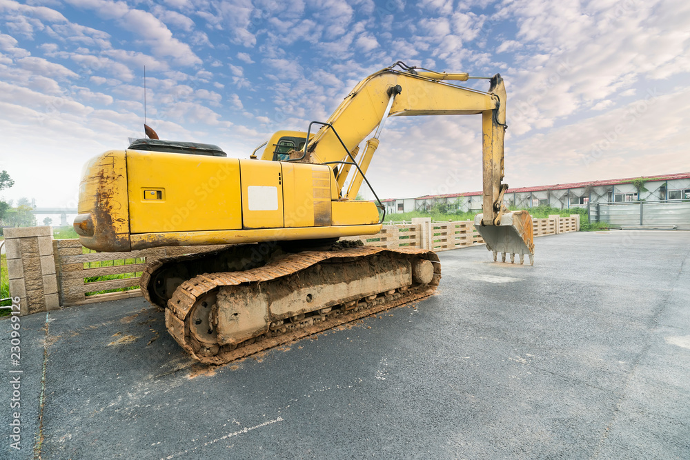 Heavy earth mover with blue sky in the background Heavy earth mover with blue sky in the background