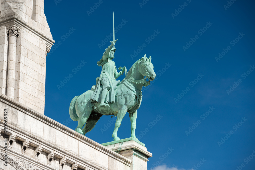 Obraz premium Statue on Basilica of the Sacred Heart of Paris or Basilica Coeur Sacre on Montmartre in Paris