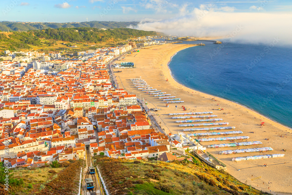 Aerial view of skyline and beach waterfront from Miradouro do Suberco in Nazare Sitio, the upper part of the city above the giant cliffs in Central Portugal, Europe.