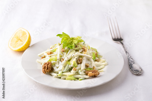 Traditional Waldorf salad with celery, apple, walnut and yoghurt dressing on white background, selective focus, horizontal