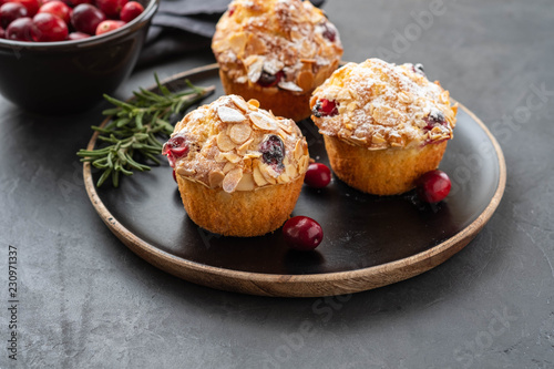 Muffins, cakes with cranberry, rosemary and almond nuts. Christmas decoration. Copy space.