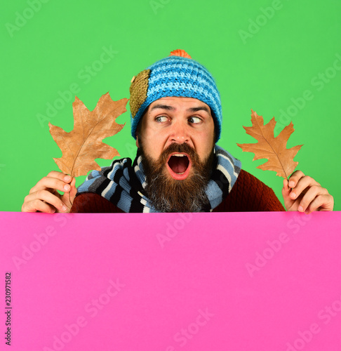 Hipster with beard and shocked face wears warm clothes