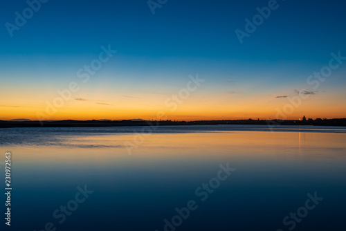 Sunset  and reflection over still water at Harrington  Australia