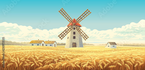 Rural autumn landscape with windmill and with houses, and wheat field. photo