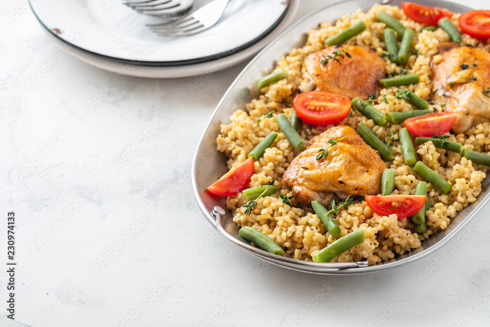 Grilled chicken thighs with bulgur, asparagus beans and tomatoes. Delicious lunch. Grilled chicken thighs with bulgur, asparagus beans and tomatoes. Delicious lunch.