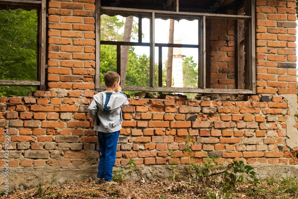 Boy in an old abandoned house