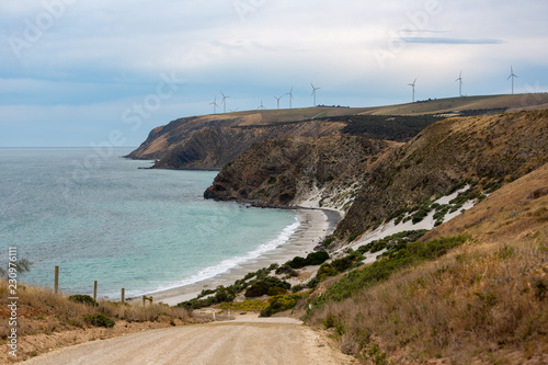 Obraz na płótnie A landscape photo of Morgans Beach Cape Jervis showing the gravel access road and the starfish windfarm in the distance located in South Australia on 1st November 2018 w salonie