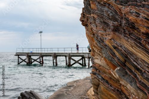 The iconic Second Valley cliff with the a selective blur of the jetty in the background taken on an overcast day on the Fleurieu Peninsula South Australia on 1st November 2018