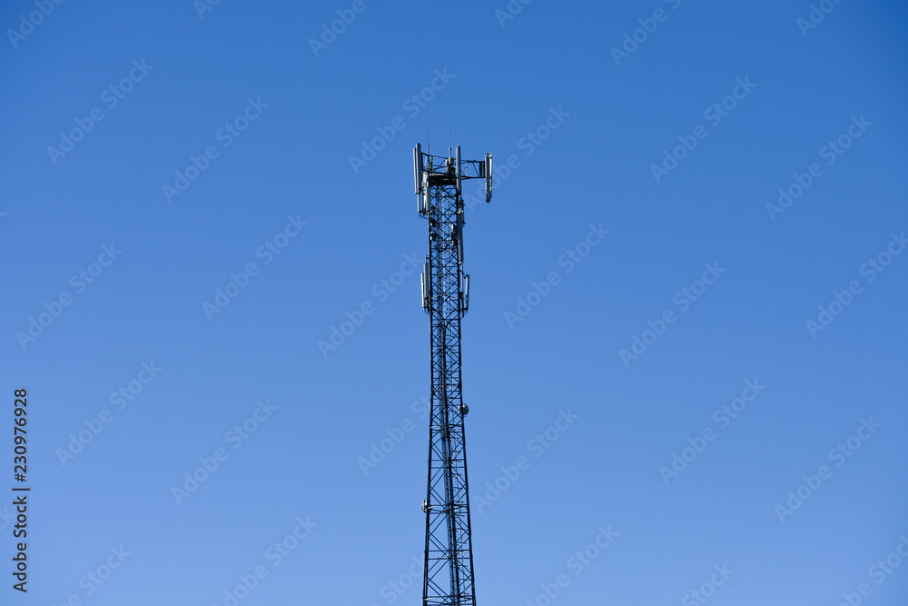Cellular radio tower antenna. Mobile GSM Base Station Tower with blue sky. Cellular radio tower antenna. Mobile GSM Base Station Tower with blue sky.
