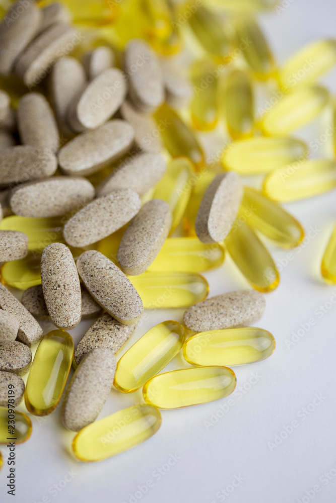 Pills and medicines scattered on the white background