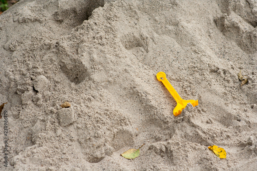 Bright plastic children's toys in the sand. Concept of beach recreation for children Bright plastic children's toys in the sand. Concept of beach recreation for children
