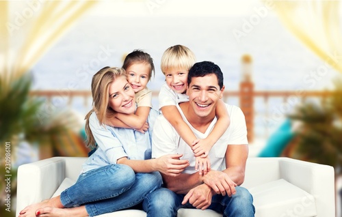 Happy family of four wearing funny glasses