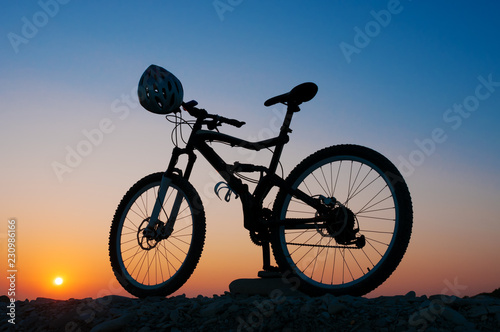 Fototapeta Naklejka Na Ścianę i Meble -  Silhouette of mountain bike at sunset
