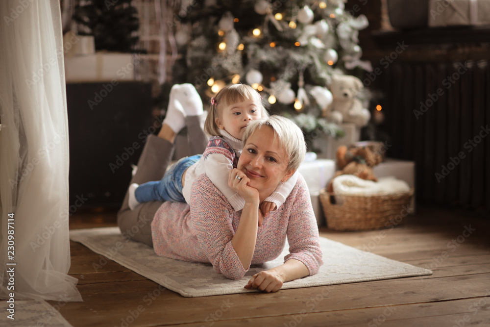 Toddler girl Down syndrome playing with mother Toddler girl Down syndrome playing with mother