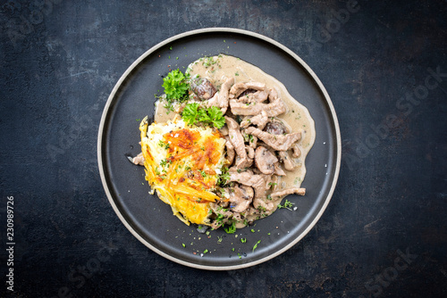 Traditional Swiss zürcher geschnetzeltes with rösti as top view in a modern style plate