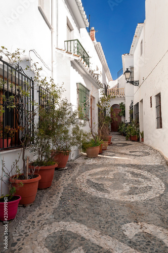 Street of white walls in a village of Andalusia called Frigiliana © Tomas