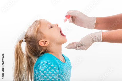 little girl on reception at the doctor receives the polio vaccine, a child being treated for influenza, the child takes the medicine in the hospitalception at the doctor takes antipyretic
 
