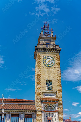 Day view of Torre dei Caduti with clock, 1924 historic stone Tower of The Fallen, at Piazza Vittorio Veneto, Bergamo, Lombardy photo