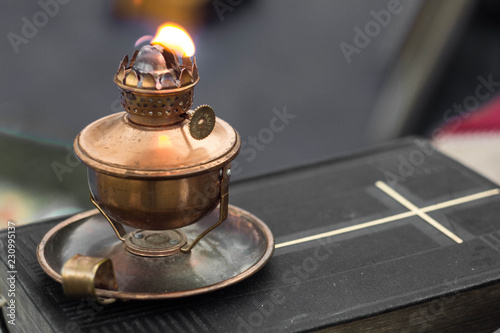Oil lamp on old bible