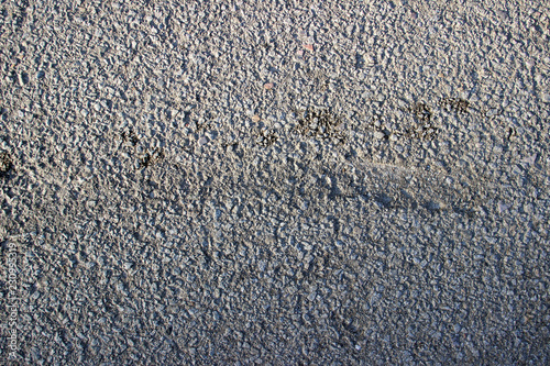Asphalt surface texture detail with oil stains close up