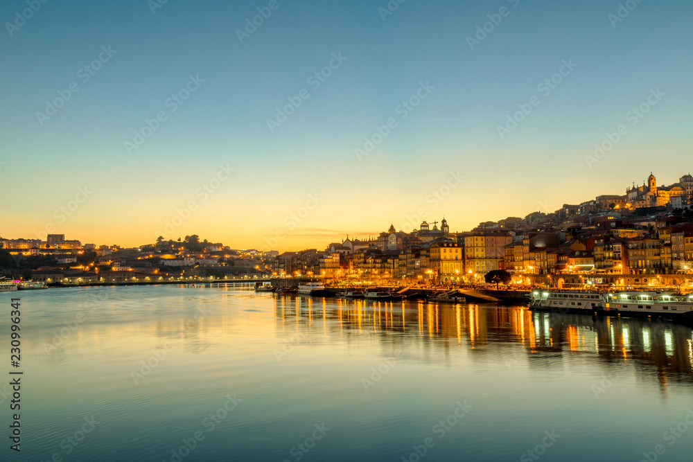 Oporto skyline reflecting on Douro River at twilight. Porto is the second Portugal's largest city. Picturesque urban evening cityscape.