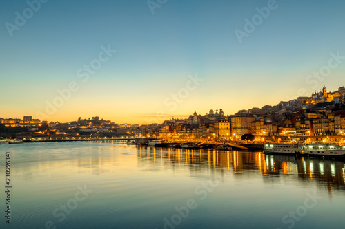 Oporto skyline reflecting on Douro River at twilight. Porto is the second Portugal's largest city. Picturesque urban evening cityscape.