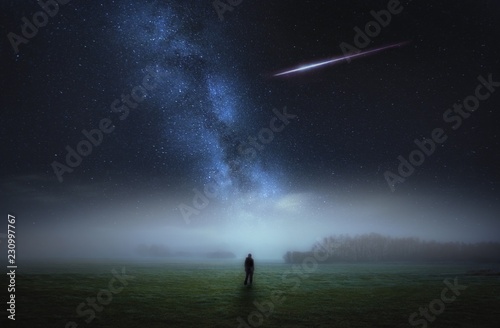 Fototapeta Naklejka Na Ścianę i Meble -  Dreamy surreal landscape with starry night sky and man silhouette