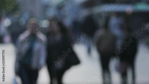 Blurred abstract footage of people walking on a city street.