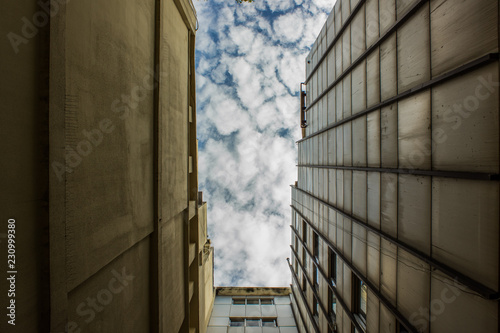 buildings urban back street corner view from below foreshortening with sky 