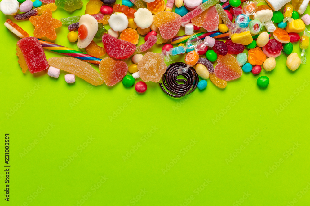 Colorful candies on green background Colorful candies on green background