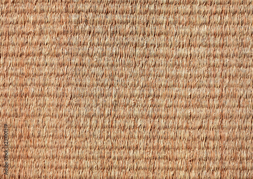 Closeup detail of table mat made of natural fiber wickerwork. 