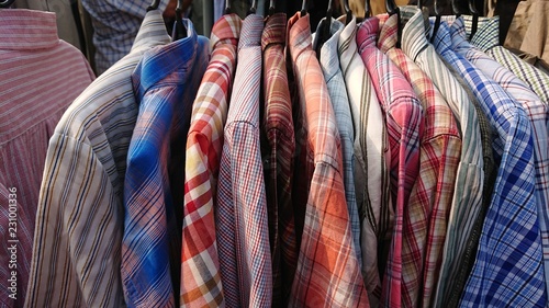 Colorful t-shirts on hangers 