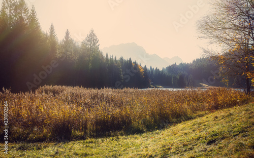Wonderful sunny landscape. Fantastic Bavarian Alps with Geroldsee lake under sunlight. Awesome misty morning . Amazing Nature background. Fairy alpine valley at autumn.
