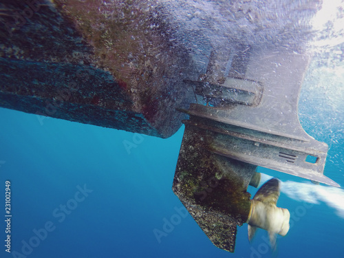 Underwater shot of running outboard motor