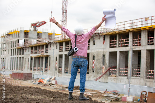 Fototapet Architect at a construction site celebrate after construction project was succes