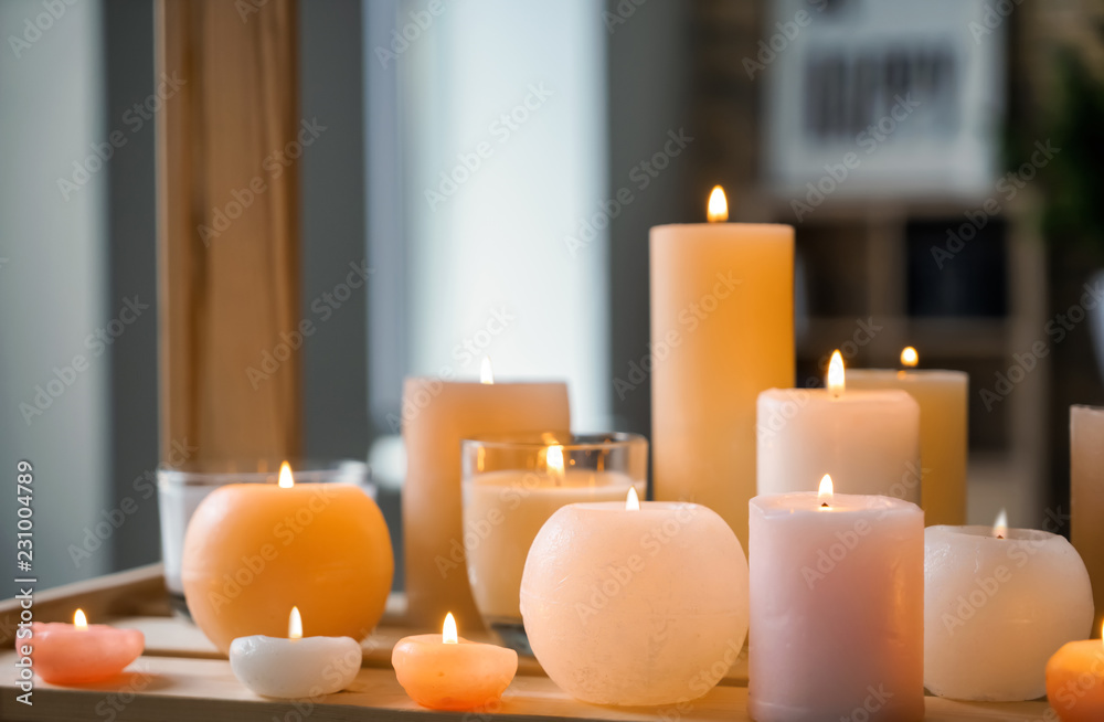 Beautiful burning candles on wooden table indoors Beautiful burning candles on wooden table indoors