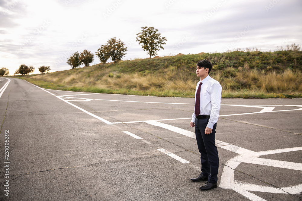 Businessman standing at crossroads. Concept of choice Businessman standing at crossroads. Concept of choice