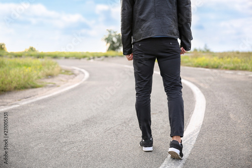 Young man going along road. Concept of choice