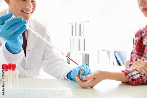 Doctor taking blood sample ...