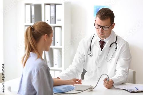 Male doctor measuring blood...