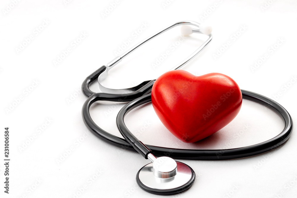 Yearly health check up, disease diagnosis medicine, healthcare and cardiology concept with a red heart and a stethoscope isolated on a hospital white background Yearly health check up, disease diagnosis medicine, healthcare and cardiology concept with a red heart and a stethoscope isolated on a hospital white background